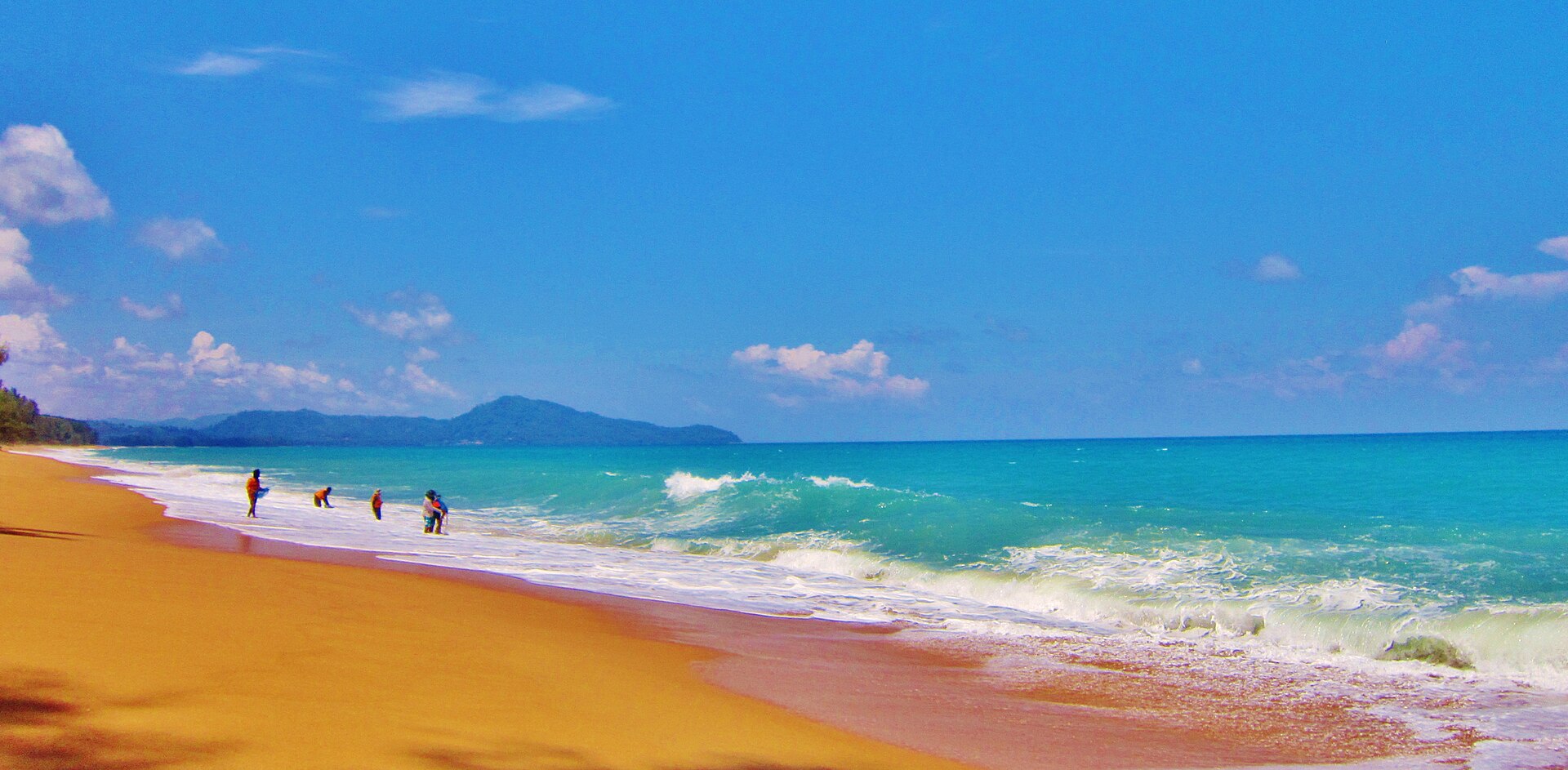 Long sandy shore of Mai Khao Beach