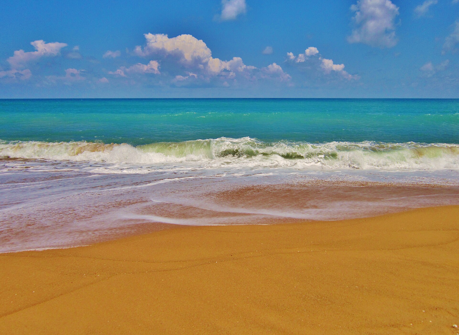 Waves on the sand at Mai Khao Beach